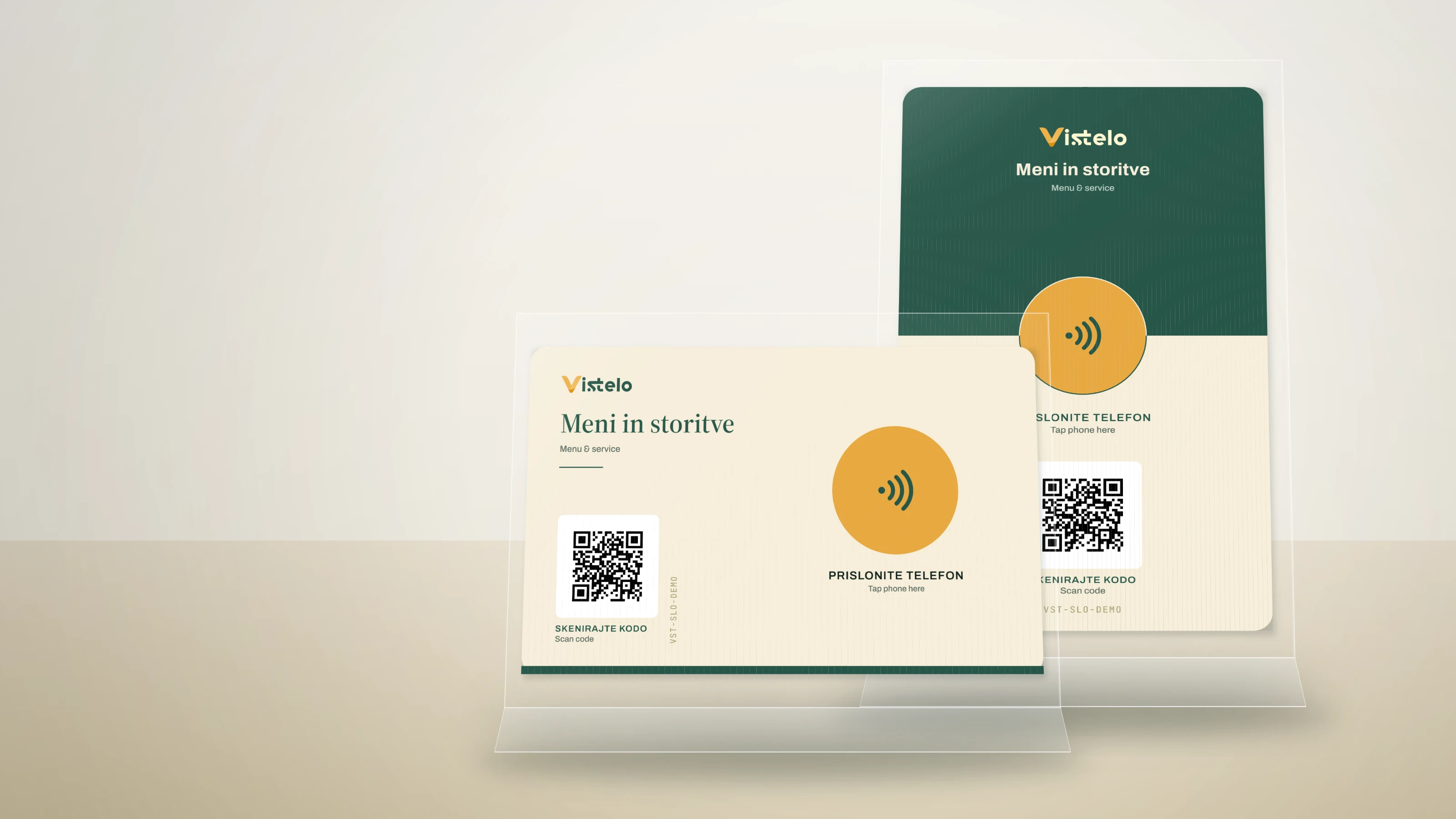 Both formats of the standard Vistelo card on a café table — a horizontal card lying flat and a portrait card standing in a holder